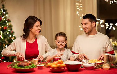 Image showing happy family having christmas dinner at home