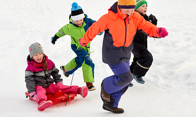 Image showing happy kids with sled having fun outdoors in winter