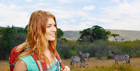 Image showing happy woman with backpack over african savannah