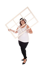 Image showing Big woman holding window frame