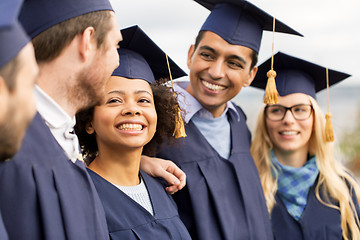 Image showing happy students or bachelors in mortar boards