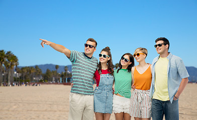 Image showing happy friends in sunglasses over venice beach