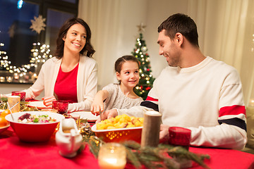 Image showing happy family having christmas dinner at home