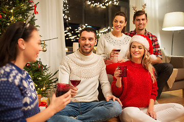 Image showing friends celebrating christmas and drinking wine