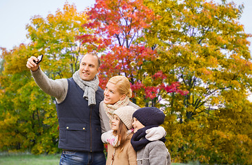 Image showing family taking selfie by smartphone in autumn park