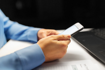 Image showing close up of hands with smartphone at night office