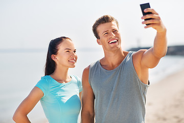 Image showing couple taking selfie by smartphone on beach