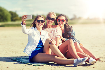 Image showing group of smiling women taking selfie on beach