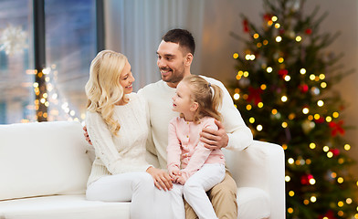 Image showing happy family at home over christmas tree lights