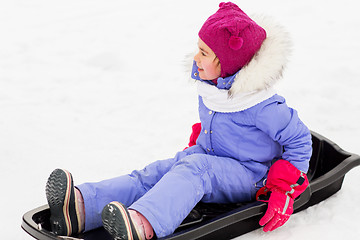 Image showing happy little girl on sled outdoors in winter