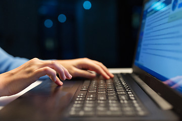 Image showing close up of female hands with laptop typing