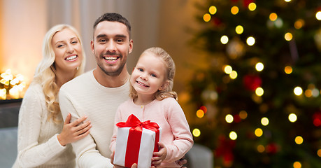 Image showing happy family at home with christmas gift