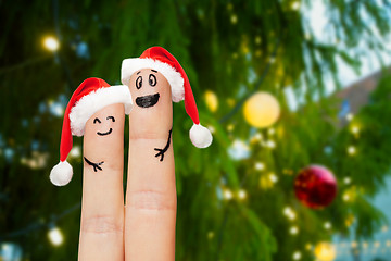 Image showing close up of finger couple over christmas tree