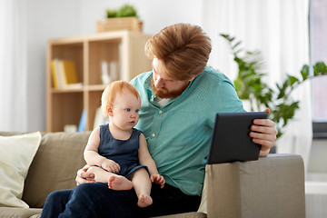 Image showing father and baby daughter with tablet pc at home