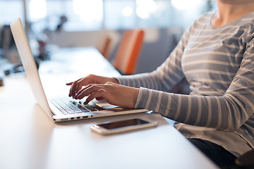 Image showing businesswoman using a laptop in startup office