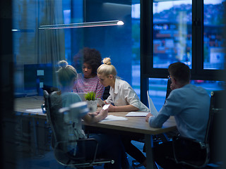 Image showing Multiethnic startup business team in night office