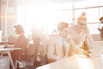 Image showing Young businesswoman helping his colleague at the work