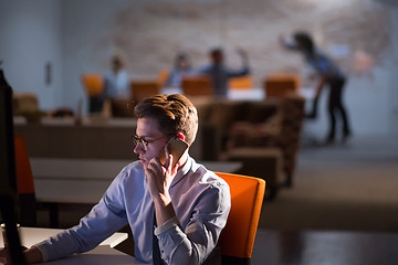 Image showing man using mobile phone in dark office