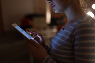 Image showing woman working on digital tablet in night office