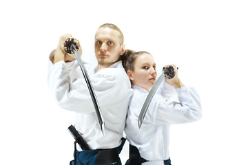 Image showing Man and woman fighting and training aikido on white studio background