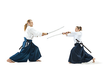 Image showing Man and woman fighting and training aikido on white studio background