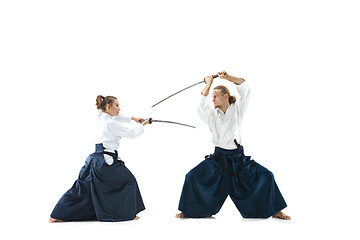 Image showing Man and woman fighting and training aikido on white studio background