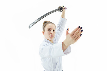 Image showing Aikido master practices defense posture. Healthy lifestyle and sports concept. Woman in white kimono on white background.