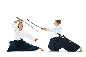 Image showing Man and woman fighting and training aikido on white studio background