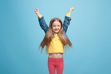 Image showing Happy success teen girl celebrating being a winner. Dynamic energetic image of female model