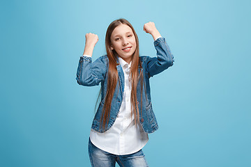 Image showing Happy success teen girl celebrating being a winner. Dynamic energetic image of female model