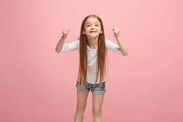 Image showing Happy success teen girl celebrating being a winner. Dynamic energetic image of female model