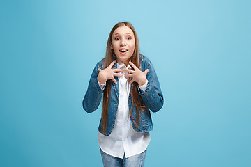 Image showing Beautiful teen girl looking suprised isolated on blue