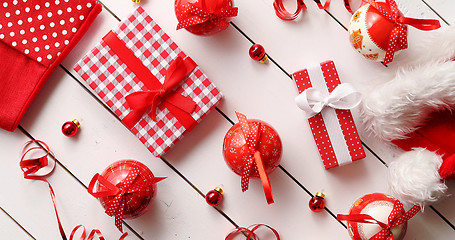 Image showing Christmas hat and baubles around gifts