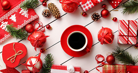 Image showing Christmas decorations and presents around coffee