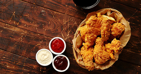 Image showing Sauces and chicken wings on table