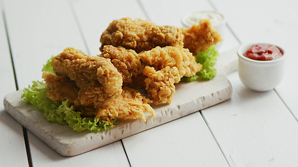 Image showing Fried meat laid on chopping board