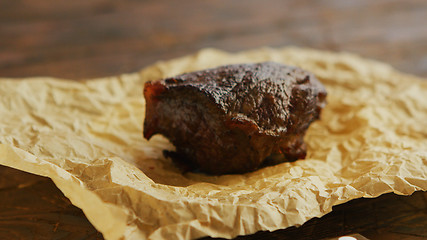 Image showing Piece of roasted meat on parchment