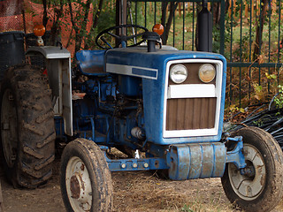 Image showing Old blue tractor in the shed with mud