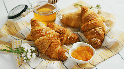 Image showing Condiments and croissants lying on towel