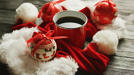 Image showing Christmas hats and baubles around hot drink