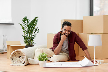 Image showing man with boxes and blueprint moving to new home