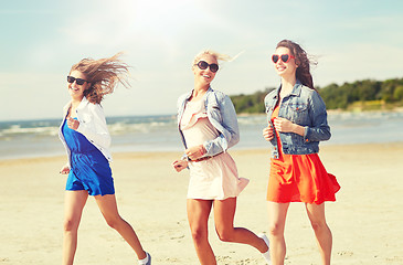 Image showing group of smiling women in sunglasses on beach