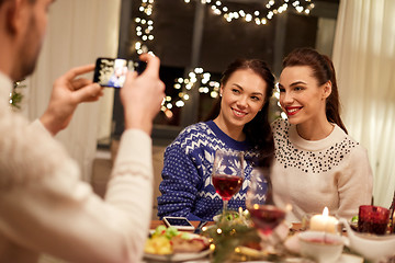 Image showing friends having christmas dinner and taking picture