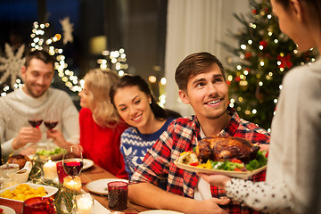 Image showing happy friends having christmas dinner at home