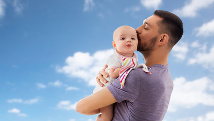 Image showing father kissing little baby daughter