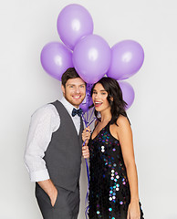 Image showing happy couple with ultra violet balloons at party