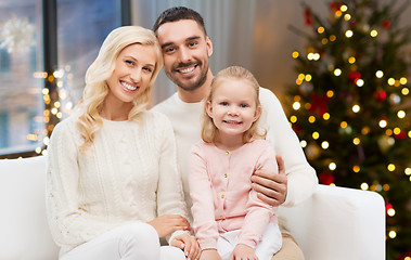 Image showing happy family at home over christmas tree lights