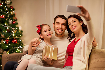 Image showing happy family with christmas present at home