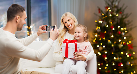 Image showing man taking picture of his family on christmas