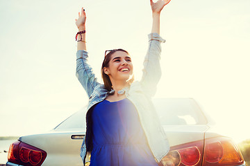 Image showing happy teenage girl or young woman near car